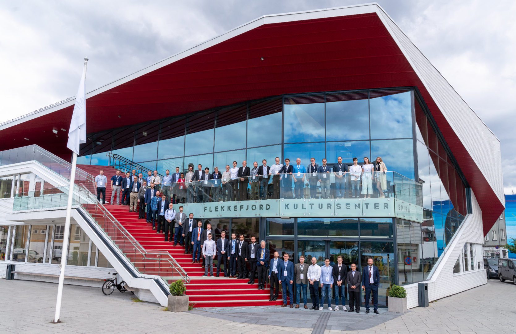 A group of people standing on top of steps.