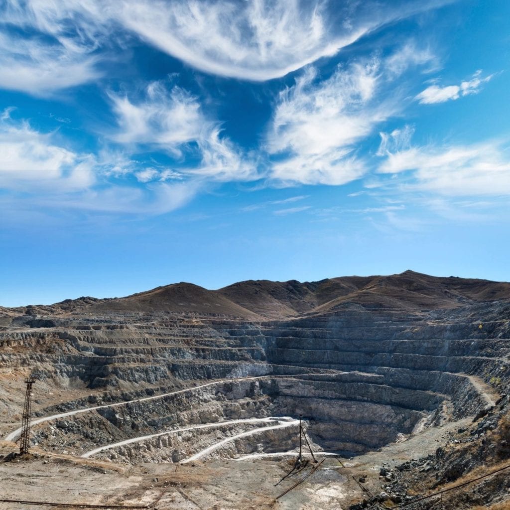 fm_f_5057 A large open pit with mountains in the background.